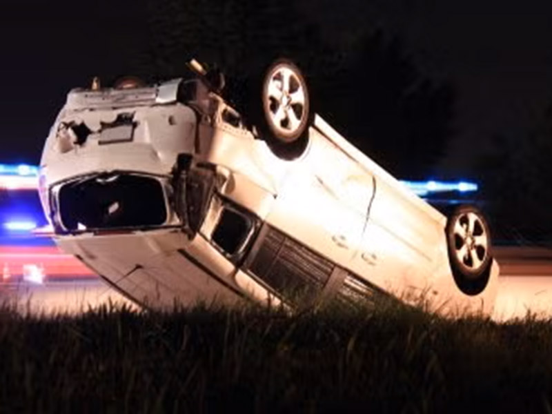 A car overturned in grass in Tracy, CA, representing a Gentleman's Agreement in legal matters.