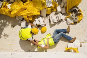 Two workers on the ground in Tracy, CA, depicting a work injury in a construction setting.