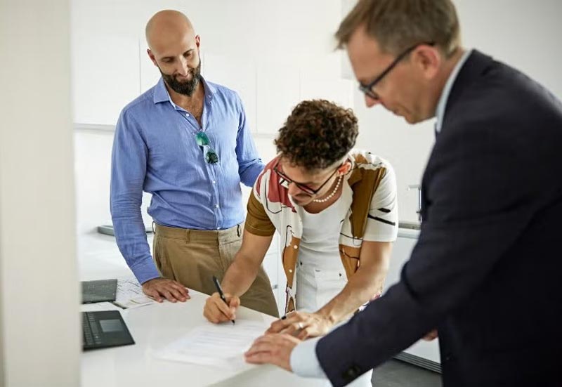 Couple Signing Legal Papers for LGBTQ+ Estate Planning in Tracy, CA