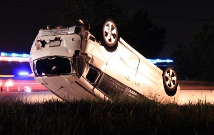 A car overturned in grass in Tracy, CA, representing a Gentleman's Agreement in legal matters.